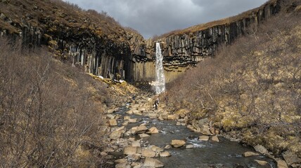 Stunning landscape of a majestic waterfall surrounded by rocks