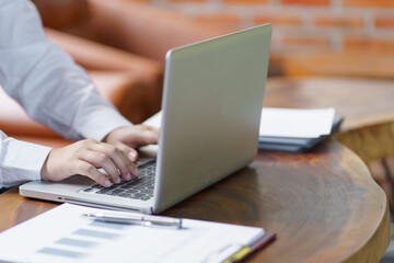 Happy young Asian Woman working on computer Business Data Analyst.