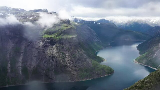 Aerial view over Norwegian Fjord and Mountains on cloudy day 