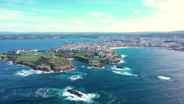 Cinematic panoramic view of A Coruna city, Galicia, Spain. Perspective from above of entire region. Riazor Beach and Orz&aacute;n beach. Drone backward. Travel destination and the richest region of Galicia
