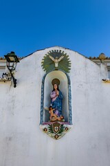 Vertical of the statue of the Virgin in a niche in Ferragudo, Lagoa, Algarve, Portugal