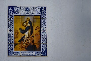 Closeup of mosaic tiles on a white wall of a building