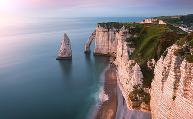 Étretat coastline located in Normandy in Northwestern France during sunset - obrazy, fototapety, plakaty