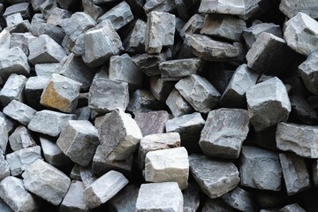Pile of bricks in various shapes and sizes, stacked haphazardly on top of one another