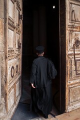 Religious devotee making his way into the Church of the Holy Sepulchre in Jerusalem, Israel