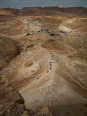 Ramp leading up to the ancient ruins of Masada, Israel, with a bright blue sky in the background