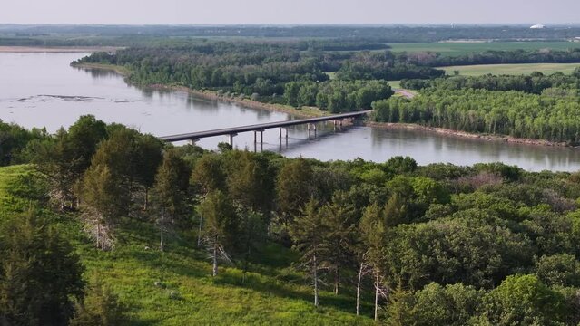 Suspension bridge over a river in a wooded area