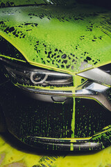 car in foam on carwash, car cleaning.