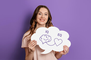 iq eq concept. girl holding poster with hand drawing a brain and heart
