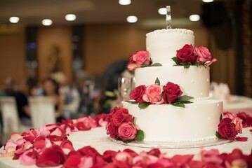 there is a triple layer wedding cake on a white table