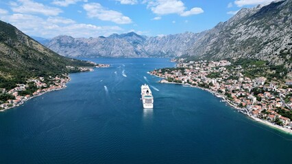 Aerial view of a harbor with a range of boats and a large cruise ship in Kotor, Montenegro - obrazy, fototapety, plakaty