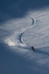 Silhouette of skier skiing on mountain