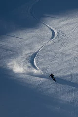 Zelfklevend Fotobehang Silhouette of skier skiing on mountain © Hristo Anestev/Wirestock Creators
