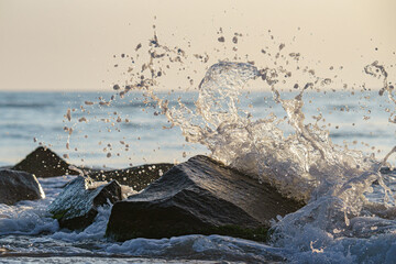 Scenic shot of waves of the sea hitting the rocks
