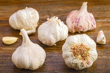 Five heads of garlic in dark wood