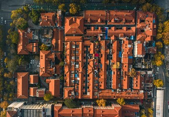 Top-down aerial view of Wuhan's cityscape with red brick building roofs during the daytime