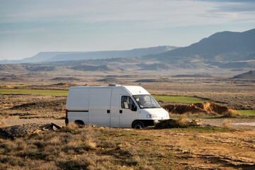 Camper van on Bardenas Reales desert landscape in Navarra, Spain