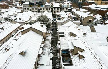 Fototapeta premium Aerial shot of buildings covered in snow in Wuhan, China.