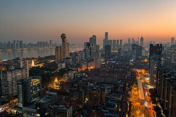 Aerial view of  vibrant night-time cityscape featuring illuminated skyscrapers in Wuhan