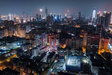 Aerial view of  vibrant night-time cityscape featuring illuminated skyscrapers in Wuhan