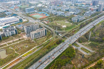 Aerial shot of a cityscape featuring a multitude of highways winding through a bustling urban area