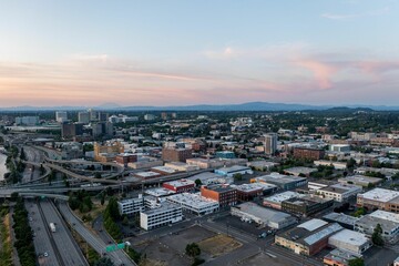 a city is lit up with sun and sunset as the clouds are starting to descend