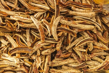 Close-up of dried bananas on a table on a sunny day