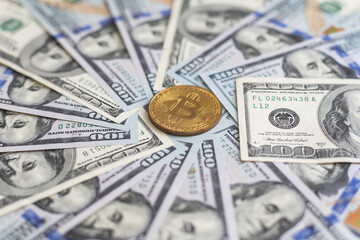 Bitcoins on dollar banknotes background, closeup 
