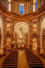 Obraz premium Interior shot of a grand church showcasing ornate pews and stained glass windows: Vienna, Austria