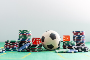 dice and soccer ball on green grass, football sports betting concept