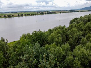 Fototapeta premium Aerial view of a lake with green vegetation at the shore