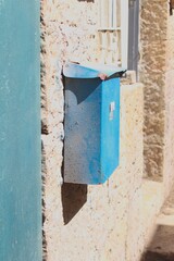 blue mailbox on a wall