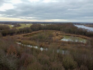 a view from a hill with a lake in the middle of it