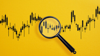 Insider trading. Stock market chart inside magnifier glass. Focus and analysis currency exchange and global trade forex concept.