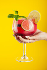 Cocktail rojo o bebida refrescante de zumos y alcohol. Tiene cítricos, menta y mucho hielo en una...