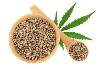 Hemp seeds in wooden bowl isolated on white background with full depth of field. Top view. Flat lay