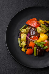 Delicious juicy fresh salad of baked eggplant, tomatoes, zucchini, onions
