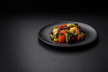 Delicious juicy fresh salad of baked eggplant, tomatoes, zucchini, onions