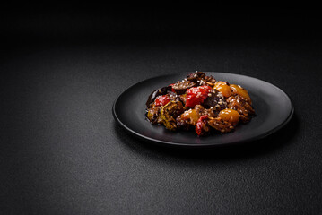 Delicious juicy fresh salad of baked eggplant, tomatoes, sweet peppers, sesame seeds