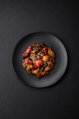 Delicious juicy fresh salad of baked eggplant, tomatoes, sweet peppers, sesame seeds