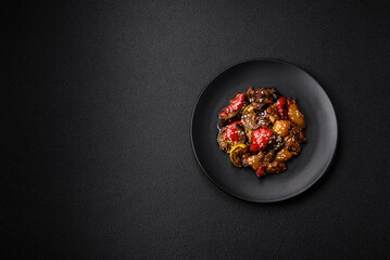 Delicious juicy fresh salad of baked eggplant, tomatoes, sweet peppers, sesame seeds