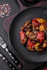 Delicious juicy fresh salad of baked eggplant, tomatoes, sweet peppers, sesame seeds