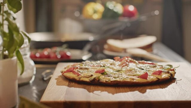 Home cooking concept - a man making paprika and spinach frittata at home. Closeup shot. Low angle.