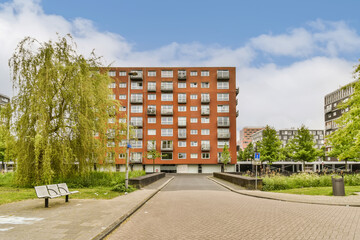 an apartment building on the street in front of some trees and buildings with blue skies overhead above, berlin, germany