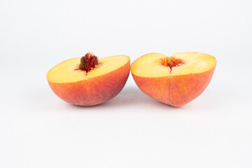 Sliced half peach with pit white background