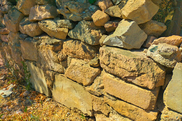 Old wall, foundation of stones, began to fall off due to the weathering of the mortar, adhering the stones together and cracks began to appear throughout the facade. Concept of the passage of time