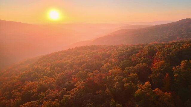 Sunrise drone aerial over colorful foggy autumn Arkansas ozark mountains and fall forest trees