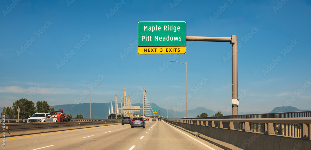 Wall mural golden ears bridge connecting maple ridge to langley. traffic on a cable-suspended bridge spanning a