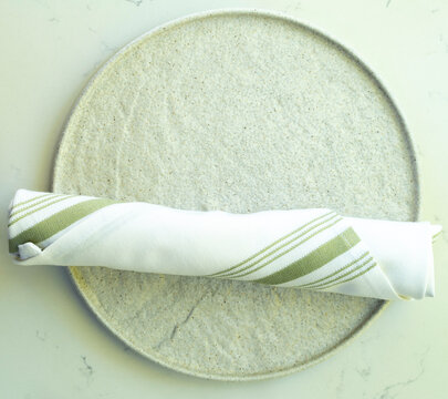 Plate With Napkin Roll On The Table