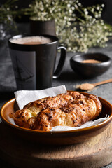 Traditional colombian food, Tequeño or Baked Cheese Stick on a brown plate and black napkin served on a dark table with hot chocolate drink, Dark food lighting